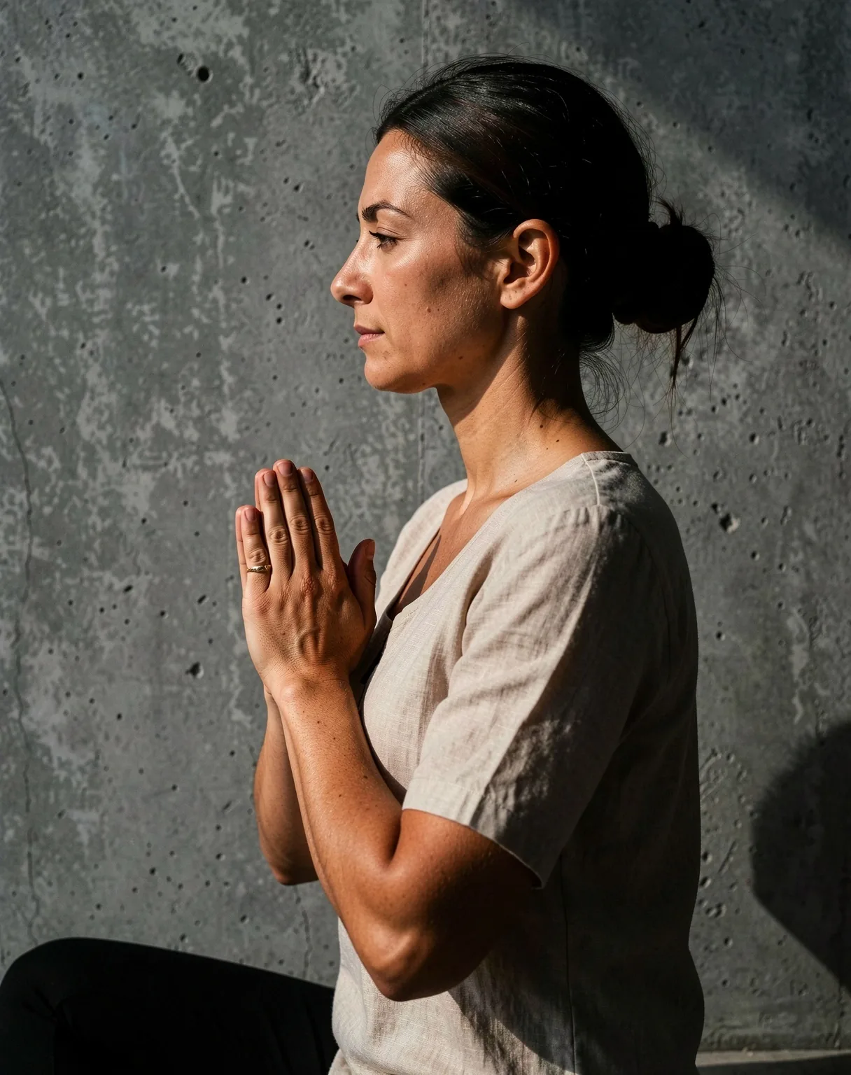 Yoga practitioner in a minimalist concrete space demonstrating alignment